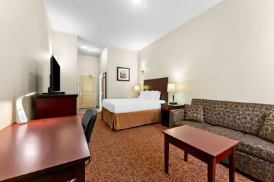 a hotel room with a couch and a bed at Best Western Williams Lake in Williams Lake