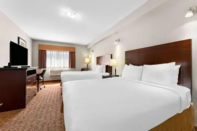 a hotel room with a large bed and a desk at Best Western Williams Lake in Williams Lake