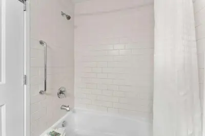 a white bathroom with a tub and a shower at Best Western Williams Lake in Williams Lake