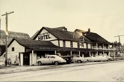 an old photo of a hotel with cars parked outside at Cariboo Lodge in Clinton