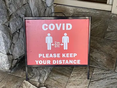 a red sign that sayscvadj please keep your distance at #433 The Aspens On Blackcomb in Whistler