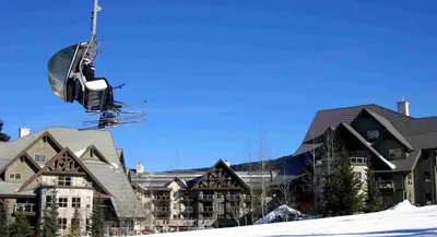 a person on a ski lift in the air at #433 The Aspens On Blackcomb in Whistler