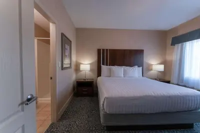 a bedroom with a bed with two lamps and a window at Prestige Cranbrook Hotel, BW Premier Collection in Cranbrook