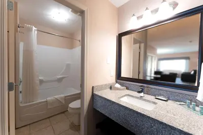 a bathroom with a sink and a toilet and a mirror at Prestige Cranbrook Hotel, BW Premier Collection in Cranbrook