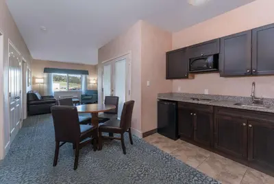 a kitchen with a table and chairs in a room at Prestige Cranbrook Hotel, BW Premier Collection in Cranbrook