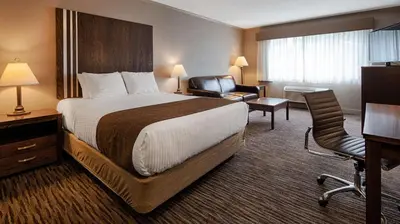 a hotel room with a bed and a chair at Best Western Mountainview Inn in Golden