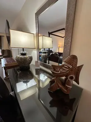 a mirror on a glass table in a living room at Bayshore Waterfront Inn in Ucluelet