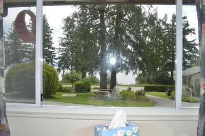 a gift box sitting on a table in front of a window at Seaside Villa Motel & RV Park in Powell River