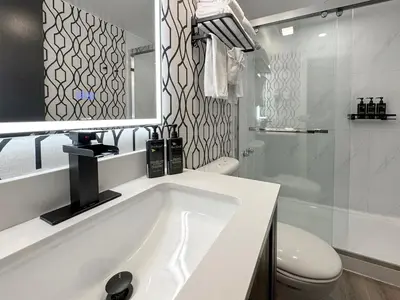 a white bathroom with a tub and a toilet at The Spot at Porpoise Bay in Sechelt