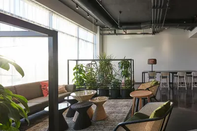 a living room with a couch and some plants at Alt Hotel Calgary East Village in Calgary