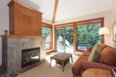 a living room with a fireplace and a couch at Montebello by Whistler Premier in Whistler