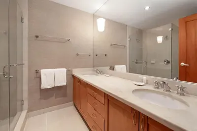 a bathroom with a sink and a shower and a mirror at Montebello by Whistler Premier in Whistler