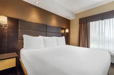 a hotel room with a large bed and a window at Best Western Cold Lake Inn in Cold Lake