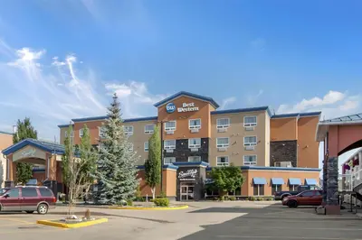 a hotel with a christmas tree in a parking lot at Best Western Cold Lake Inn in Cold Lake