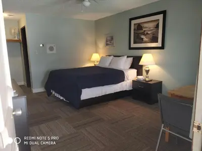 a hotel room with a bed and two lamps at Pleasant Valley Motel Houston in Houston