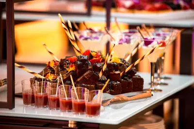 a table with a tray of desserts and drinks at Holiday Inn Edmonton South - Evario Events by IHG in Edmonton