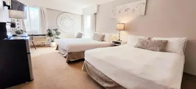 a hotel room with two beds and a couch at Western Lodge in Kimberley