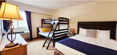 a bedroom with two bunk beds and a ladder at Western Lodge in Kimberley