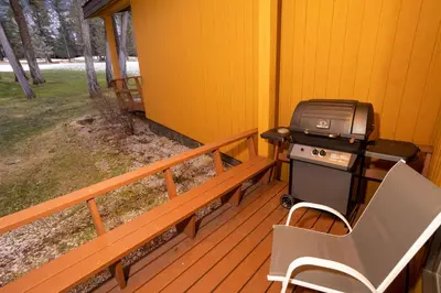 a grill on the back porch of a house at Fairmont Hot Springs Resort in Fairmont Hot Springs