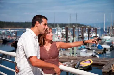 a man and a woman standing next to a marina at Painted Turtle Guesthouse in Nanaimo