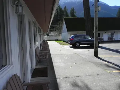 a car parked on the side of a house at Skagit Motel in Hope