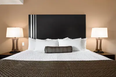 a bedroom with a large bed with two lamps at Days Inn by Wyndham Calgary Northwest in Calgary