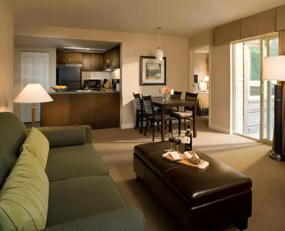a living room with a couch and a dining room at Executive Suites Hotel and Resort, Squamish in Squamish
