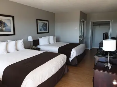 a hotel room with two beds and a television at Island View Lodge in Powell River