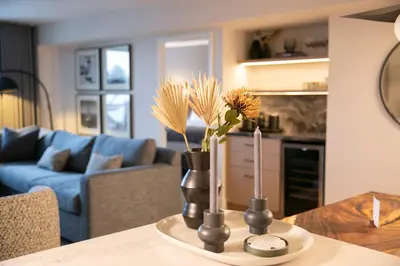 a table with two vases with flowers in a living room at Carleton Lodge in Whistler