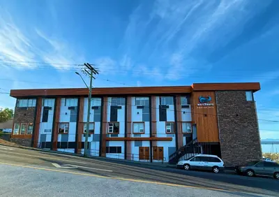 a building with cars parked in front of it at Waterways, A Boutique Hotel in Powell River