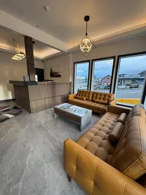 a living room with a couch and a table at Waterways, A Boutique Hotel in Powell River