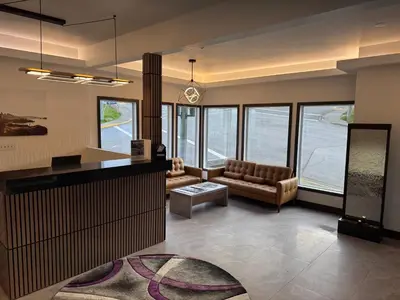 a living room with a couch and a table at Waterways, A Boutique Hotel in Powell River