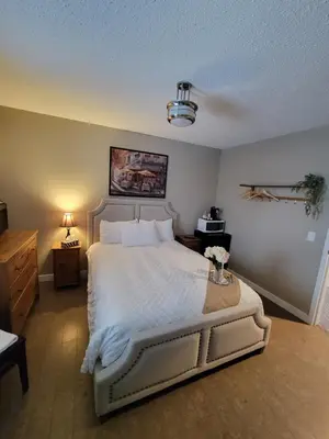 a bedroom with a large white bed in a room at Royal Duke Hotel in Okotoks