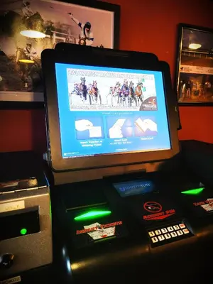 a video game machine with a horse racing game on it at Royal Duke Hotel in Okotoks