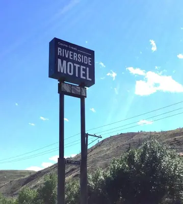a blue street sign on the side of the road at Riverside Motel Cache Creek in Cache Creek