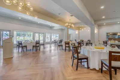 a dining room with tables and chairs in a restaurant at Bayside Resort, an Ascend Collection Resort in Parksville