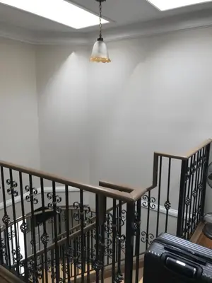 a staircase with a light and a suitcase at Royalty B&B in Richmond