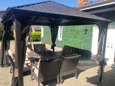 a gazebo with a table and chairs under it at Royalty B&B in Richmond