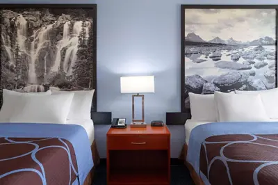 a hotel room with two beds and a table with a lamp at Super 8 by Wyndham Sherwood Park/Edmonton Area in Sherwood Park