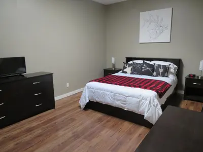a bedroom with a bed and a dresser at Kimberley Downtown Accommodation in Kimberley