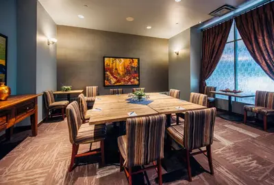 a conference room with a wooden table and chairs at The Explorer Hotel in Yellowknife