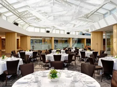 a banquet hall with white tables and chairs at Inn at Laurel Point in Victoria
