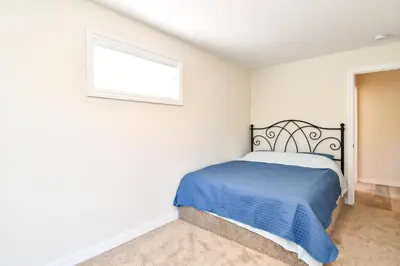 a bedroom with a bed and a window at Chateau Riverside in Campbell River