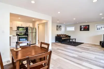 a kitchen and living room with a wooden table at Chateau Riverside in Campbell River