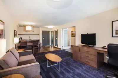 a living room with a couch and a tv at Holiday Inn & Suites Grande Prairie by IHG in Grande Prairie