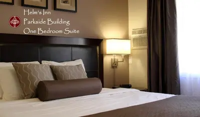 a hotel room with a bed with a black headboard at Helm's Inn in Victoria
