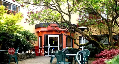 a table and chairs in front of a building at Helm's Inn in Victoria