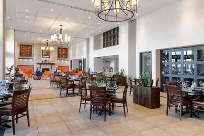 a dining room with tables and chairs in a restaurant at Walnut Beach Resort in Osoyoos