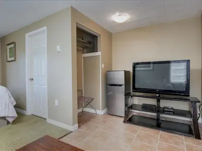 a living room with a large flat screen tv at Malahat Bungalows Motel in Malahat