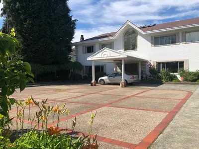a house with a car parked in a driveway at Vancouver shaughnessy guest home in Vancouver